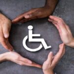 Close-up Of A Hands Protecting Disabled Handicap Icon